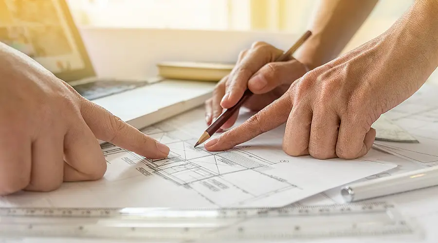 Hands working on blueprint