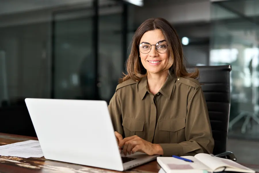 Stock photo of a woman in front f a laptop.