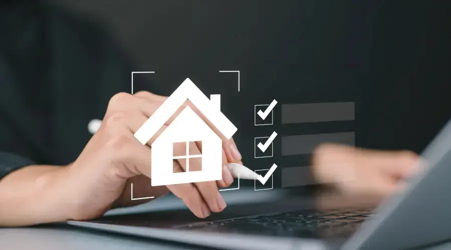 Stock photo of a laptop and house graphic with checkbox.